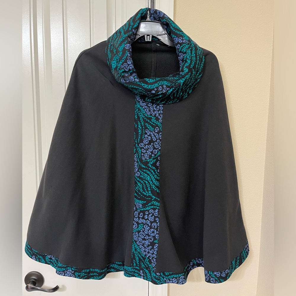 Black cape with design around neck and bottom